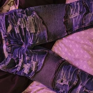 Ripped blue jeans with zippers